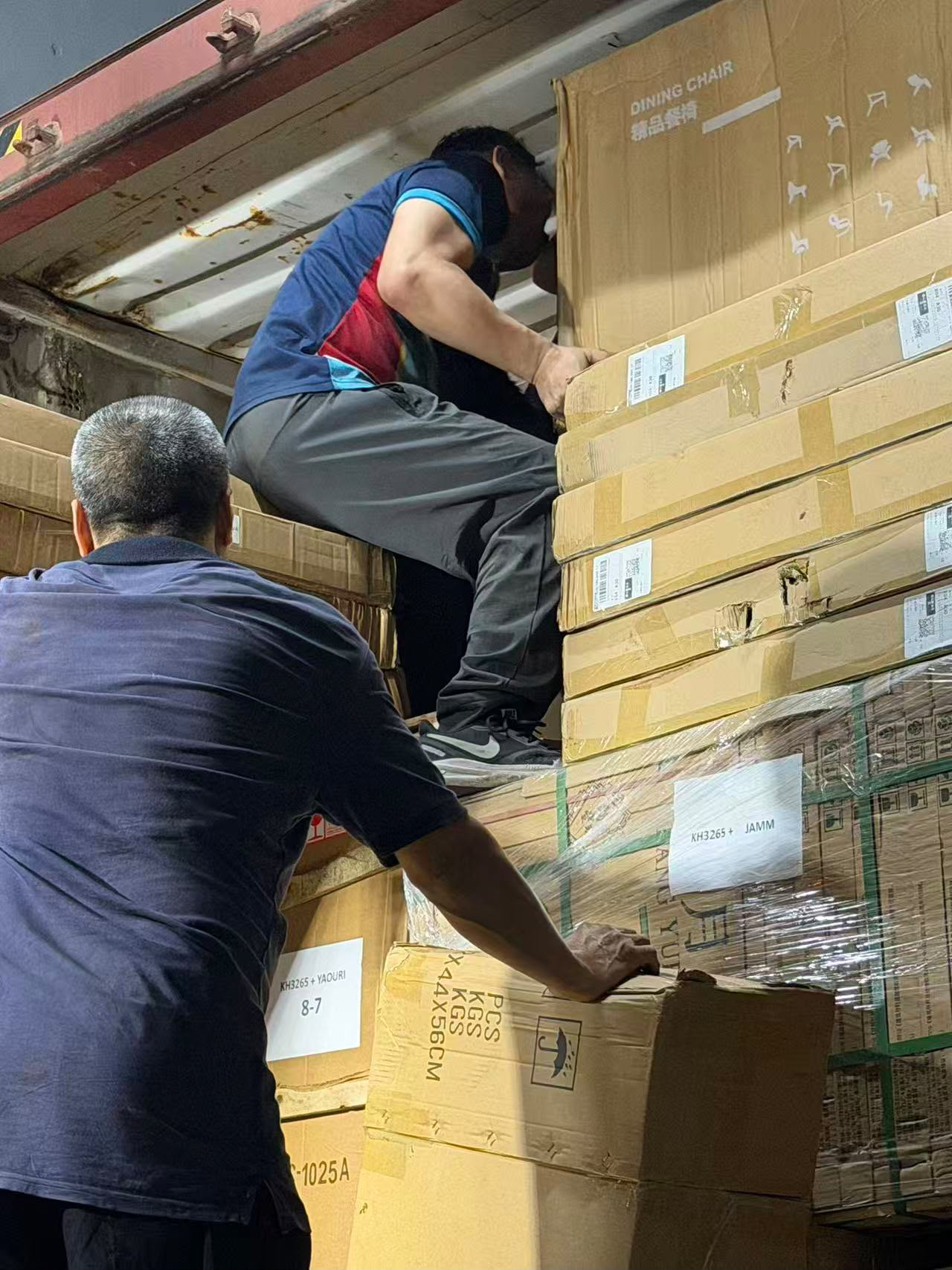 JAMM team supervising container loading at night